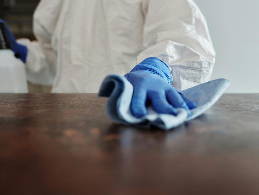 A cleaner wiping down a service